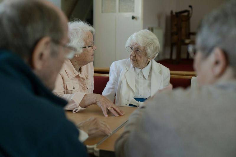 Older people talking together around a table